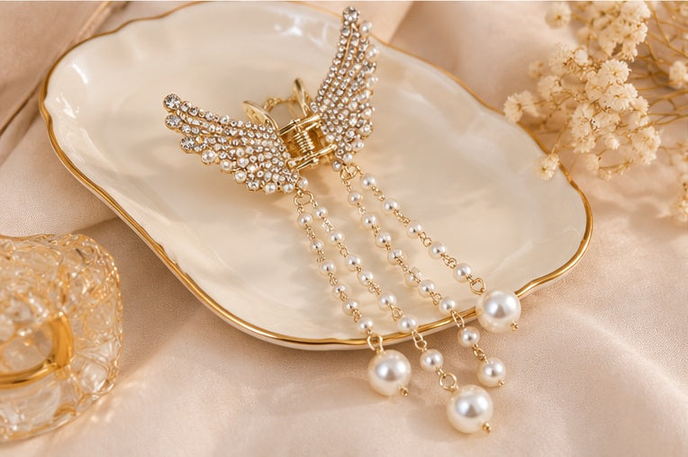 Butterfly pearl chain hair catcher on an elegant dish, product view