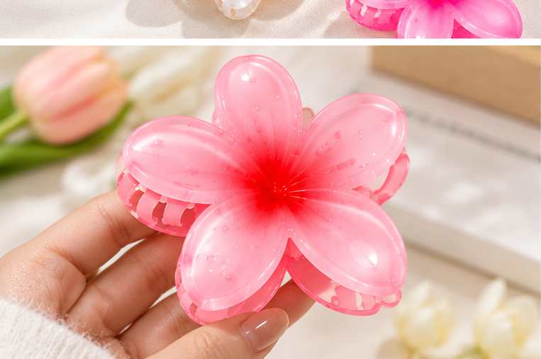 Close-up of translucent pink flower hair claw catcher