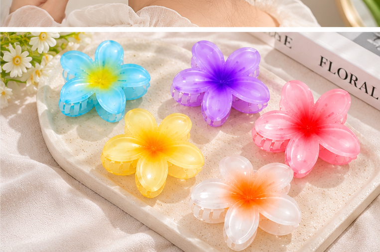 Colorful flower hair claw catchers arranged on a tray