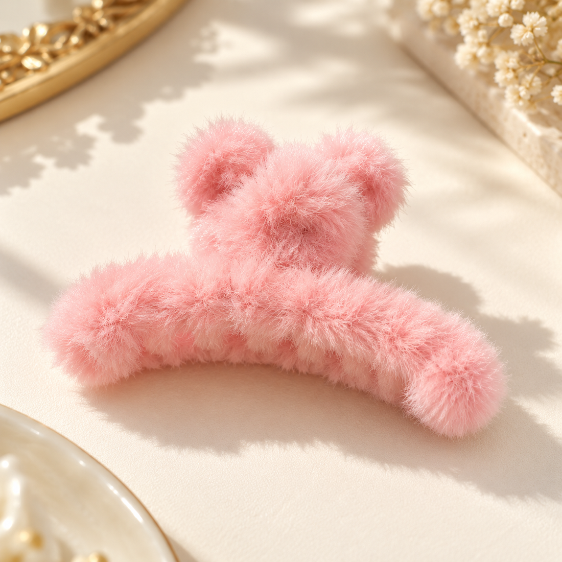 Pastel pink fuzzy hair claw clip on ivory background