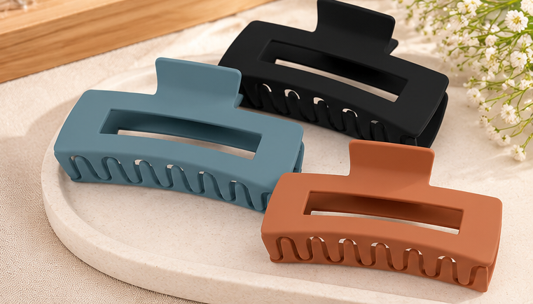 Three matte rectangular hair claw clips arranged for product display