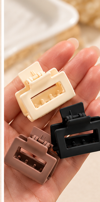 Small cream, brown and black claw clips shown in hand