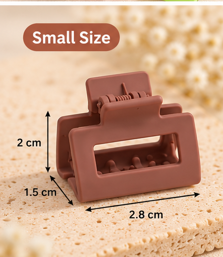 Assorted small rectangular claw clips arranged on a tray